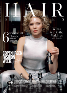 four diverse woman with different hair colors and lenghts, which stand side by side and close to each other looking into the camera while standing in front of a clean grey background